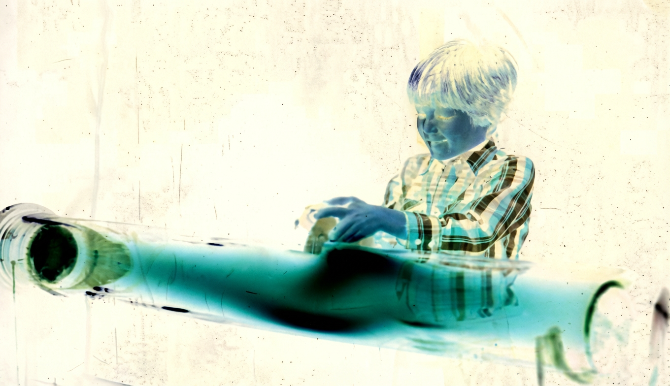 Enfant jouant avec un aimant et un tube de décharge de plasma